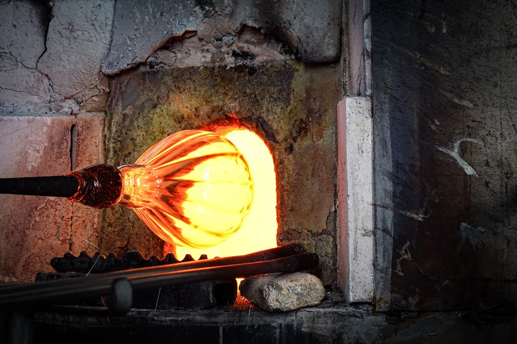 Blow glass at a furnace among houses moved here plank by plank