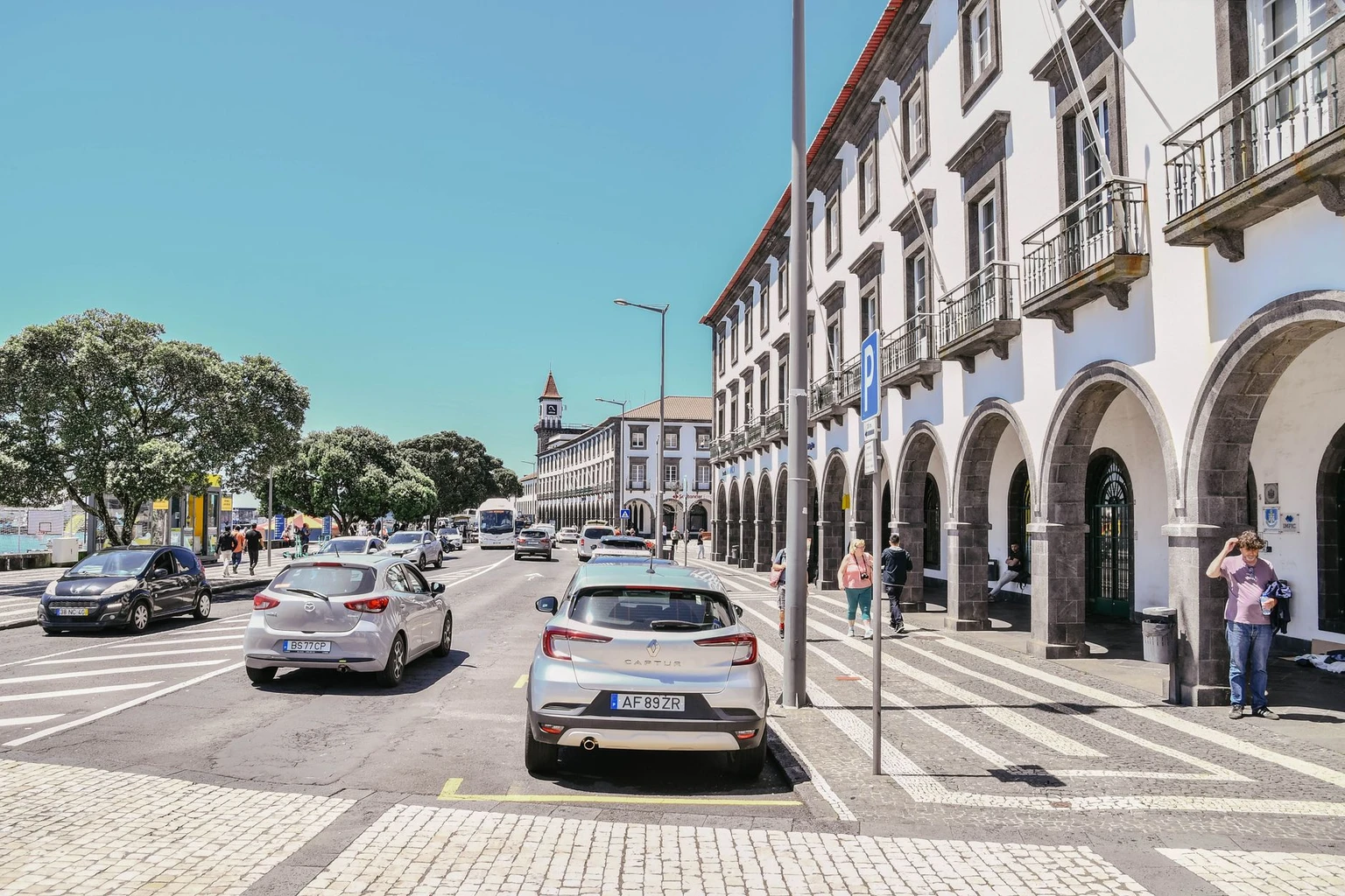 Street view of Ponta Delgada with historic architecture and bustling afternoon activity.