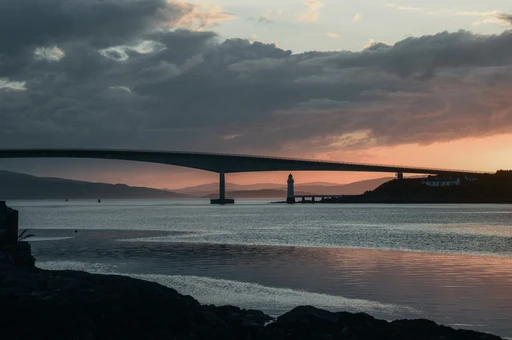 Scenic view of Skye Bridge and lighthouse during a stunning sunset.