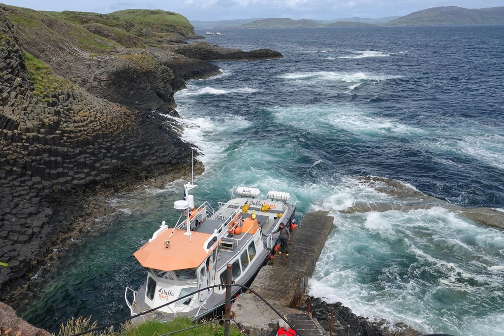Step off a boat onto an island of basalt columns