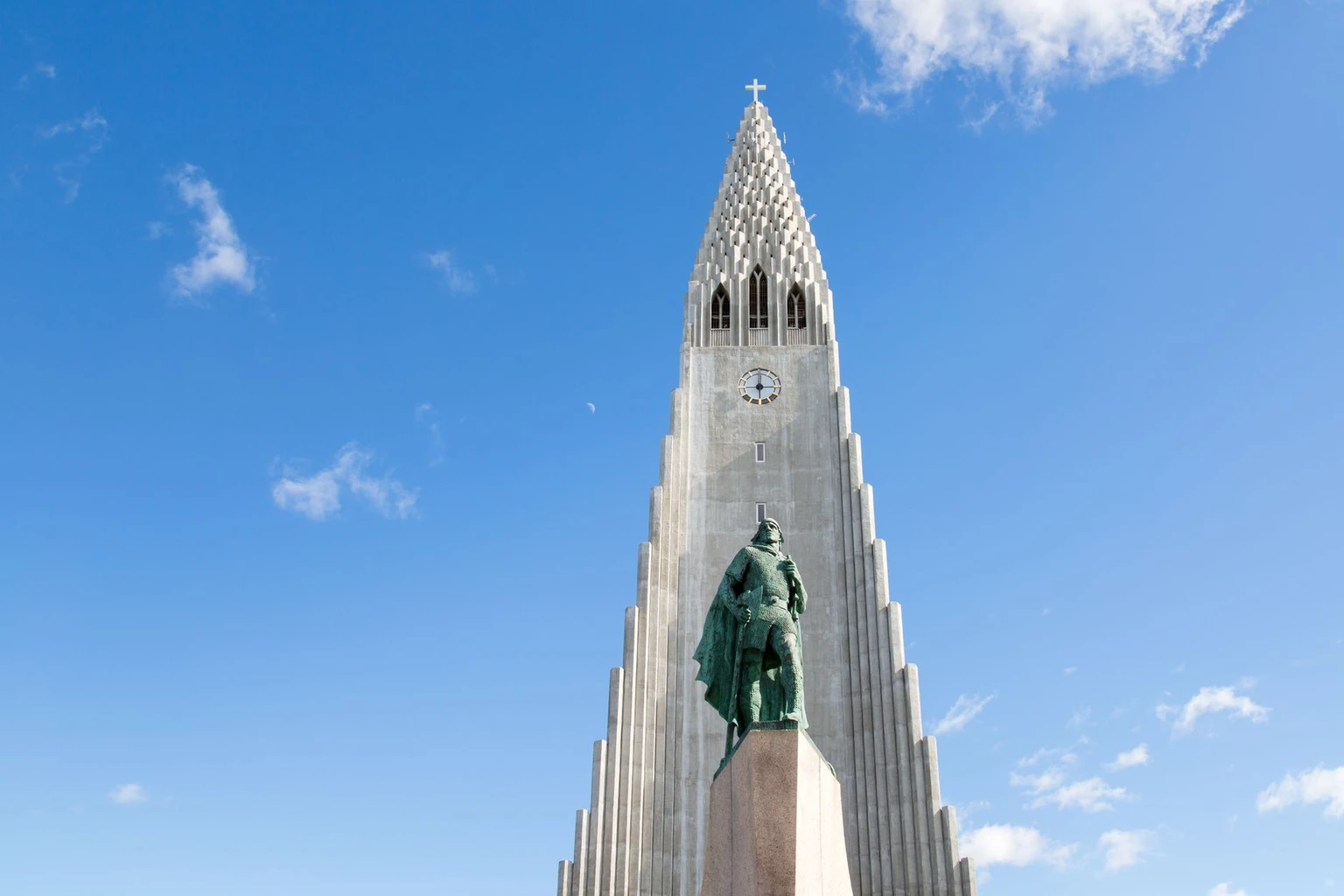 View of Hallgrímskirkja Church and Leif Erikson statue under a clear Icelandic sky.