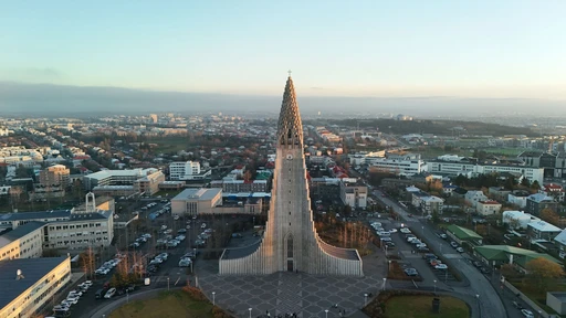 Stunning aerial shot of Hallgrímskirkja in Reykjavik, Iceland, at sunrise showcasing the city's architecture.