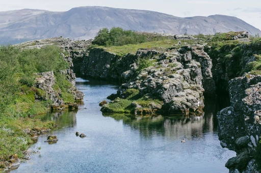 Explore the serene beauty of Flosagja Canyon in Iceland’s Thingvellir National Park, a UNESCO World Heritage site.