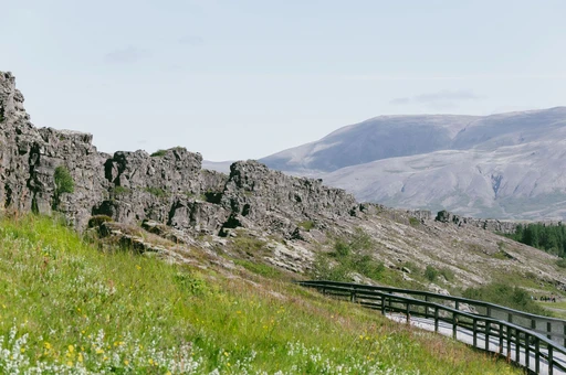 Stunning view of rocky cliffs and footpath at Þingvellir National Park, Iceland.