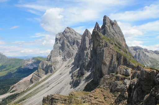 Rocky Seceda peaks rising against a bright blue sky.