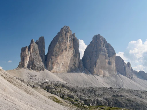 The three towers of the Tre Cime di Lavaredo under a clear blue sky.