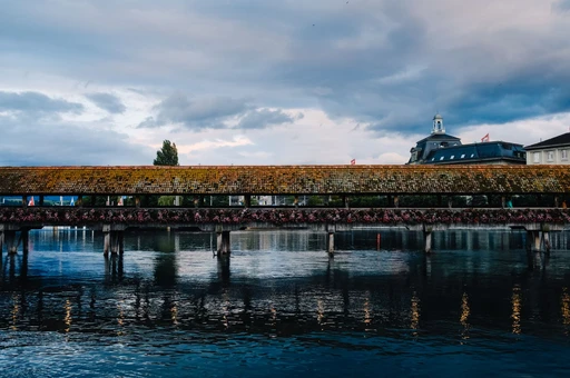 Explore the historic Chapel Bridge spanning the Reuss River in Lucerne, Switzerland.
