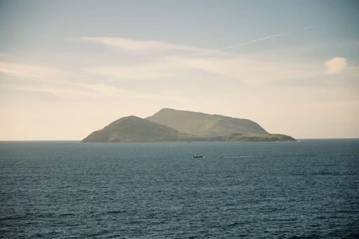 Beautiful view of the Blasket Islands in Ireland captured from the sea under a clear sky.