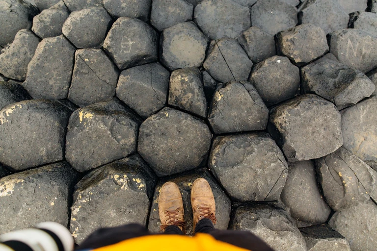Step from column to column across the Giant's Causeway
