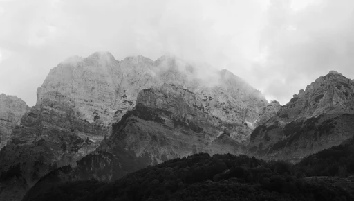 Striking black and white photo of the majestic mountains in Theth, Albania.