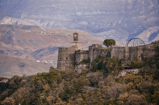 Gjirokaster Fortress stands majestically amidst the Albanian mountains, showcasing rich history and stunning architecture.