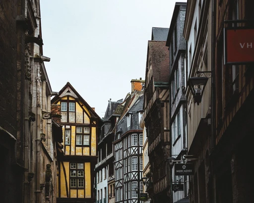 A narrow street in Rouen lined with half-timbered houses.
