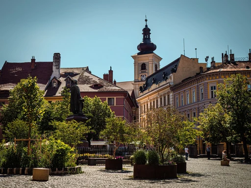 A square in Sibiu's old town with the Council Tower rising behind the rooftops.