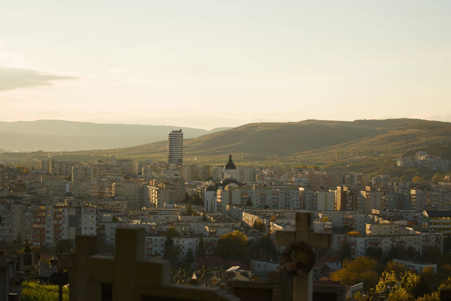 Cluj-Napoca against the surrounding hills at sunset.