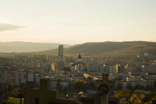 Cluj-Napoca against the surrounding hills at sunset.