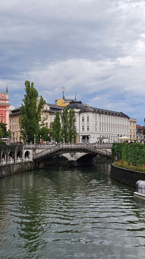 Picturesque view of Ljubljanica River and Triple Bridge in Ljubljana, Slovenia, showcasing classic architecture.