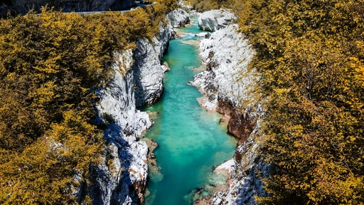 Discover the stunning turquoise waters of the Soca River flowing through the scenic landscape of Slovenia.
