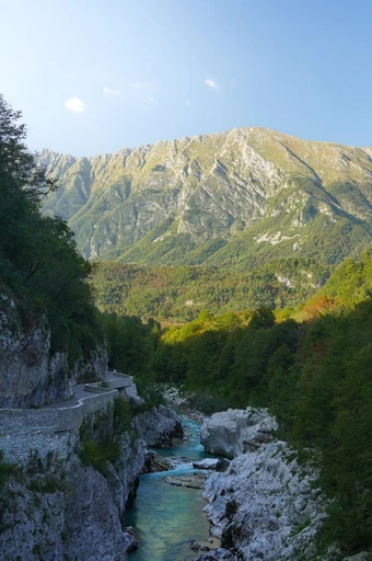 Breathtaking view of the Soča River surrounded by mountains in Kobarid, Slovenia.
