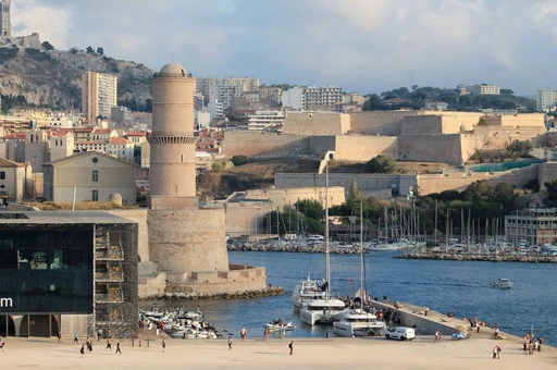 Fort Saint-Jean at the mouth of Marseille's Old Port, with boats and the harbor beside it.