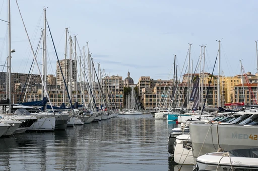 Sailboats moored in the Old Port of Marseille with the city behind.