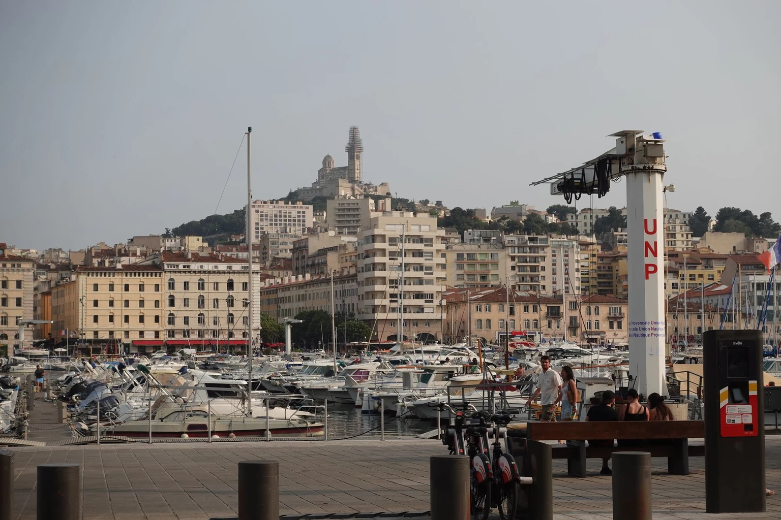Boats in Marseille harbor with Notre-Dame de la Garde on the hill behind.