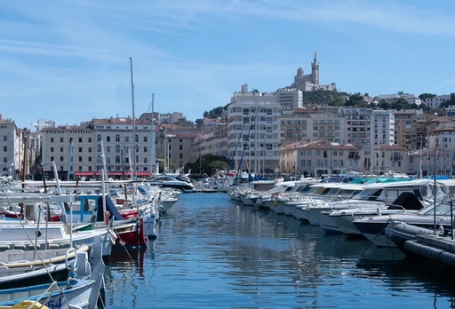 Yachts in the Vieux-Port of Marseille with Notre-Dame de la Garde above the city.