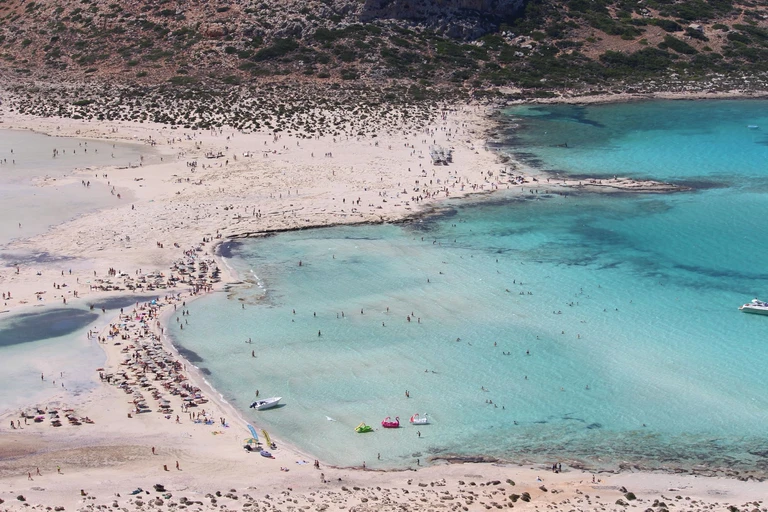 Wade into a lagoon with pink in its sand