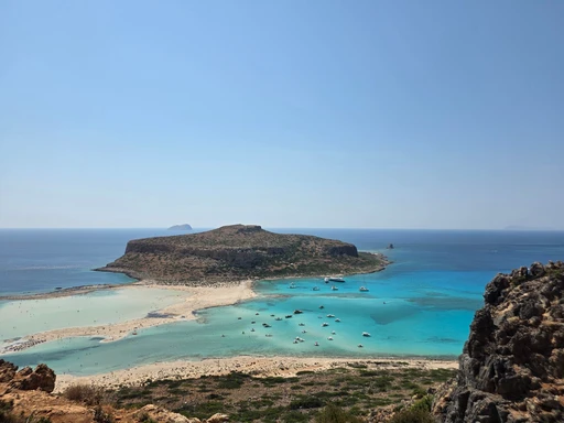 View from the cliff down over Balos lagoon, its pale sand and the rocky Gramvousa headland.