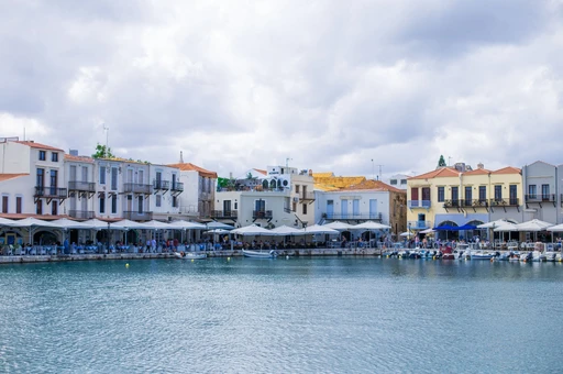 Rethymno's waterfront with colorful buildings and a calm harbor.